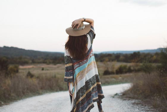 Woman Walking Down a Dirt Road